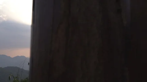 Dolly shot of mountain range landscape in hazy evening sky Stock Footage 87764244