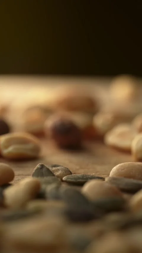 Dolly shot moving over mixed nuts and seeds Stock Footage 332924018