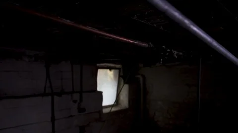 Dolly shot of an old and creepy basement. Tubes, pipelines, dirty walls and a Stock Footage