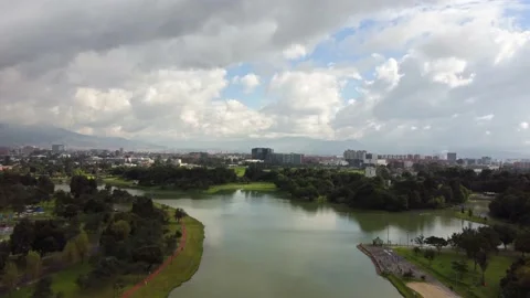 Dolly in shot over a lake in Simon Bolivar Park. Bogota City in the Vídeos de archivo 162564010