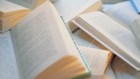 Dolly shot over many open books Stock Footage 73567453