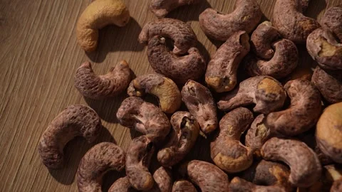 Dolly shot over raw cashew nuts on wooden surface Stock Footage 314263083