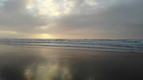 Dolly Shot Over Wet Sand and Surf, Sunset Stock Footage