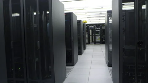 Dolly shot panning past men working in server room Stock Footage 64518478