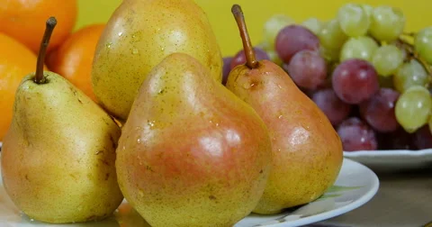 Dolly shot from pears to apples close up, grapes and oranges in background Stock Footage 60749071