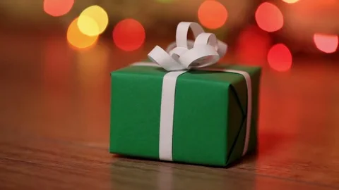 Dolly shot of present box against blurry lights Stock-Footage 81118361