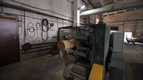 Dolly shot of Processing of round timber logs for building wooden house Stock Footage 126522365