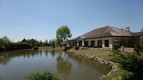 Dolly shot of restaurant exterior with trees, lakes. Beatiful nature near the Stock Footage
