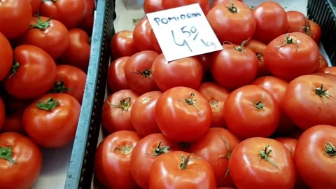 Dolly shot right to left over different type of tomatoes for sale Stock Footage 69938419