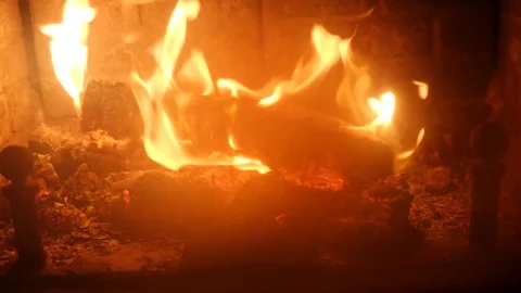 Dolly shot of a roaring fire in a cozy fireplace in room Stock Footage 84920568