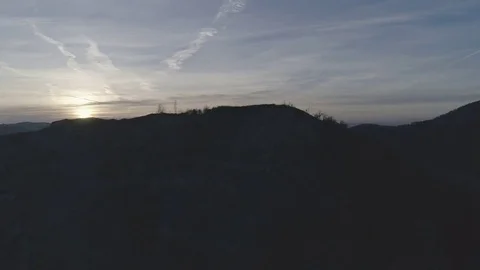 Dolly shot of a rock mining complex revealing a sunrise over the city Graz, 4K Stock Footage 73781682