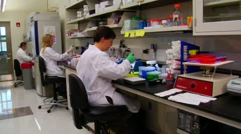 Dolly shot of scientists at work in laboratory 스톡 동영상 21530114