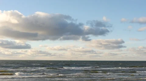 Dolly shot of sea with clouds and shining sun appearance time lapse Stock Footage 59160656
