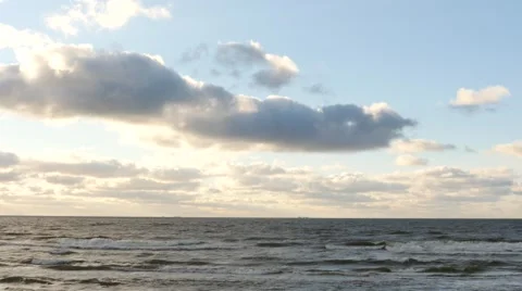 Dolly shot of sea waters with clouds and shining sun time lapse Stock Footage 59160589