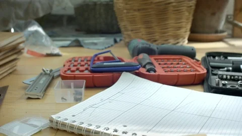 Dolly shot of set of tools and drawings Stock Footage 76814587