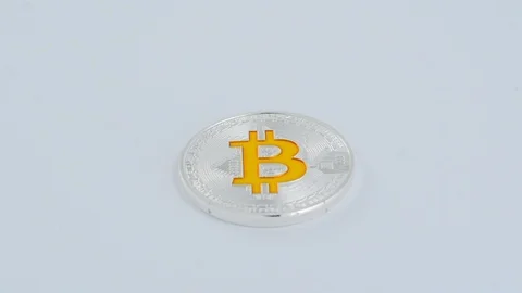 Dolly shot of silver bitcoin BTC coin with golden bitcoin symbol. Stock Footage 99548356