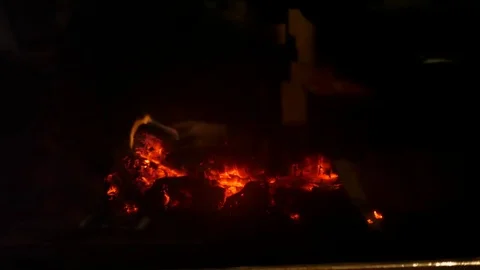 Dolly shot of a small fire in cozy fireplace in room Stock Footage 84921008