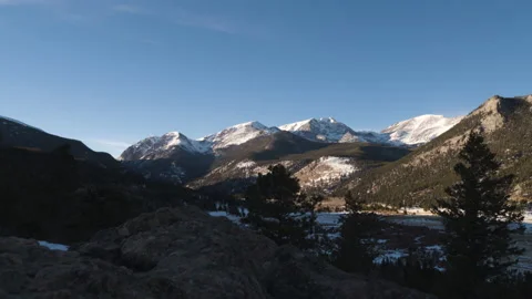 Dolly shot of Sun setting over distant Rocky Mountains Stock-Footage 170589760
