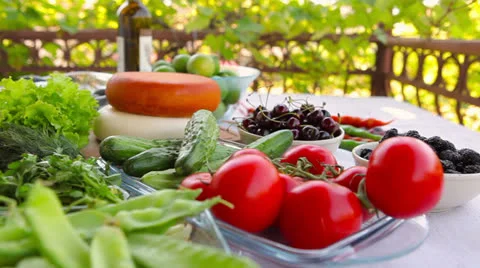 Dolly shot of table full of fresh food in the garden Stock Footage