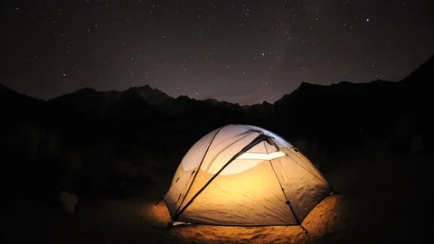Dolly shot of a tent and star trail time lapse below Mount Whitney in the Sierra Stock Footage
