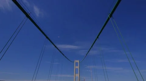 Dolly shot up at the  tower and supporting cables of the Mcackinac Bridge Stock-Footage 68950783