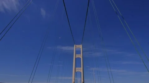 Dolly shot up at the  tower and supporting cables of the Mcackinac Bridge Stock Footage 68950815