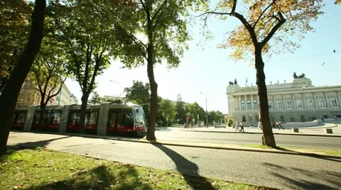 Dolly shot of  tram through the trees on the Vienna boulevard Stock Footage 21446188
