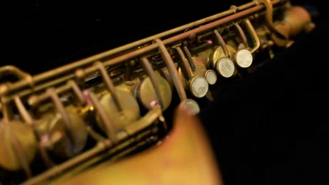 Dolly shot of a very old rusty alto saxophone with black background Stock-Footage 100356242