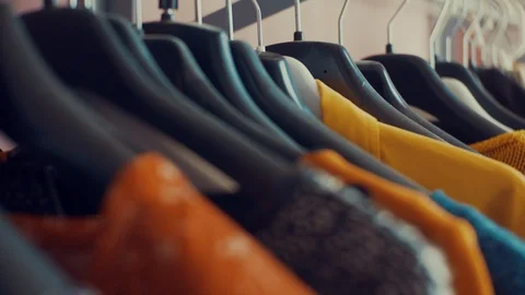 Dolly shot of wardrobe hanger with multi-colored clothes in the store. colorful Stock Footage 104852552