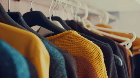 Dolly shot of wardrobe hanger with multi-colored clothes in the store. colorful Stock Footage 104852562