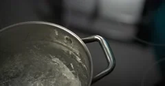 Medium Shot Dolly Shot Clear Glass Pot Of Water Boiling On Stove