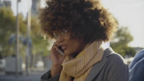 Dolly shot of woman talking on smart phone in city Stock Footage