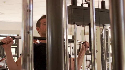 Dolly shot of young man exercising at gym. Stock Footage 43666384