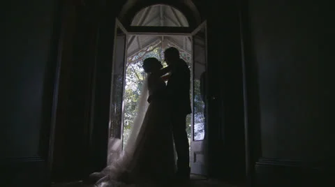 Dolly silhouette Bride & Groom kissing Stock Footage