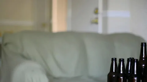 Dolly slide, group of empty beer bottles on a table Stock Footage 22559156