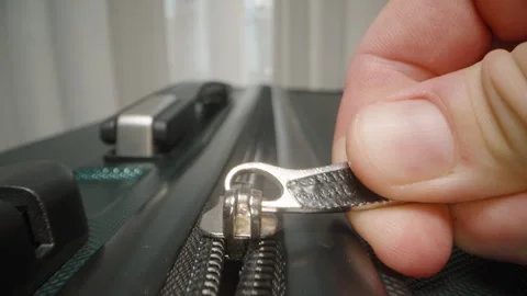 Dolly slider, close up. Fingers pull the zipper shut, securing luggage in Stock Footage 282287677