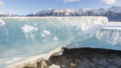 Dolly slider time lapse of thick ice in the mountains above running water Stock Footage 85211116