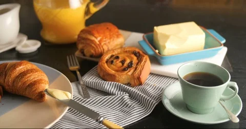 Dolly sliding view of a French breakfast with pastries, orange juice and coffee Stock Footage 72376853