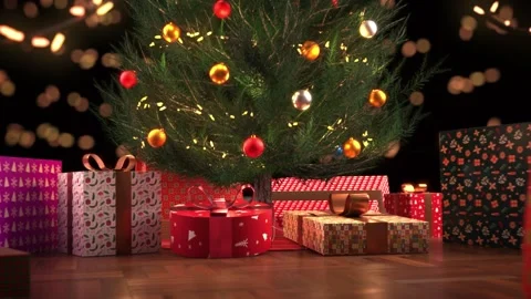 Dolly in on a small decorated christmas tree whose foot is covered with gifts Stock Footage 221240379