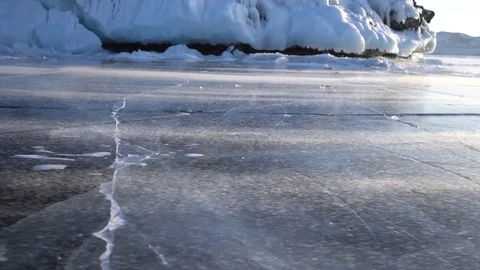 Dolly Strong wind bears snow Lake Baikal Olkhon blue ice crack detail Winter Video stock 88166693