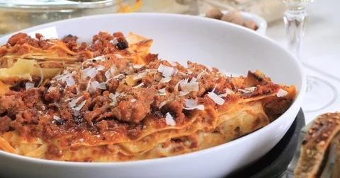 Dolly top down close up view of delicious steamy lasagne in bolognese sauce Stock Footage 74070186