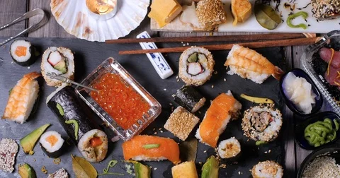 Dolly top down view of an assortment of Japanese food: sushi, nigiri, sashimi Stock-Footage 76760603