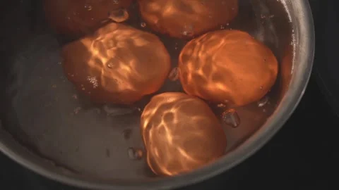 Dolly top view of brown eggs boiling in kitchen pot Stock Footage 312767240
