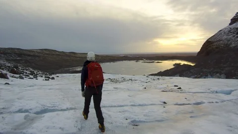 Dolly tracking shot camera follows a lonely mountaineer going down from mountain Stock Footage 94134324