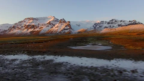 Dolly tracking shot right side view driving alongside meadow foothills mountains Stock Footage 95197244