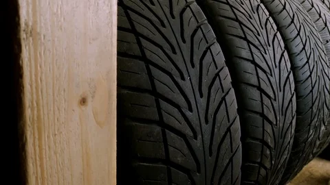 Dolly in of tyre stack in indoor store, close up view Stock Footage 126808249
