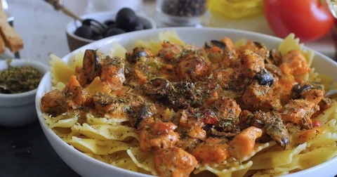 Dolly view of delicious pasta with fresh salmon and black olives Stock Footage 72953335