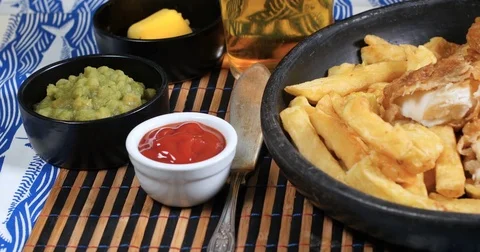 Dolly view of an English fish and chips with garden peas Stock Footage 75278917