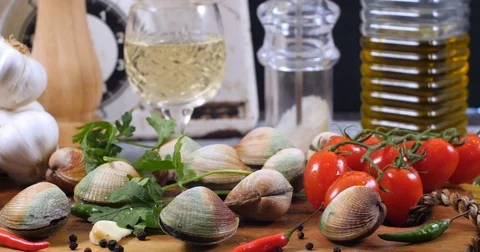 Dolly view of ingredients for delicious spaghetti alle vongole (clams) Stock Footage 76183074