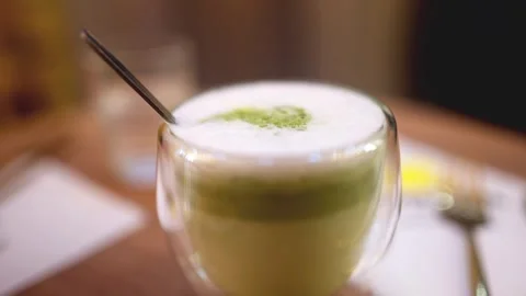 Dolly view to a matcha latte coffee beverage Stock Footage 316886659